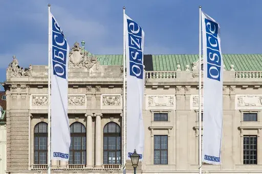 Flags wave in the wind in front of the entrance of the Permanent Council of the Organization for Security and Cooperation in Europe, OSCE, in Vienna, Austria, Feb. 15, 2022. Neutral Austria has come under heavy criticism for granting visas to sanctioned Russian lawmakers for a meeting of the Organization for Security and Cooperation in Europe in Vienna from Feb. 23 until Feb. 24, 2023. The issue highlights the delicate balancing act the European country has engaged in while trying to maintain it