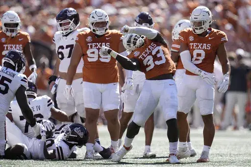 Texas linebacker David Gbenda (33) celebrates after a stop during the first half of an NCAA college football game against Mississippi State in Austin, Texas, Saturday, Sept. 28, 2024. (AP Photo/Eric Gay)
