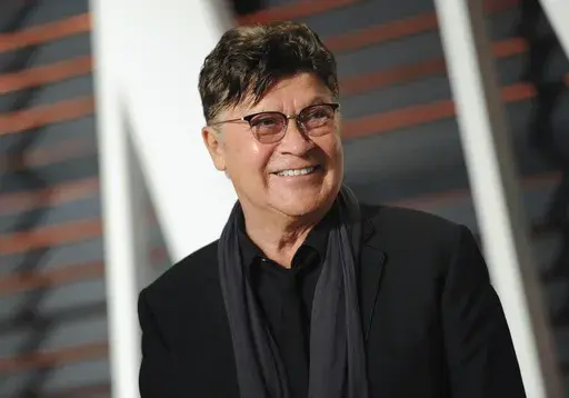 Musician Robbie Robertson arrives at the Vanity Fair Oscar Party on Sunday, Feb. 22, 2015, in Beverly Hills, Calif. Robertson, the lead guitarist and songwriter for The Band, whose classics include “The Weight,” “Up on Cripple Creek” and “The Night They Drove Old Dixie Down,” has died at 80, according to a statement from his manager. (Photo by Evan Agostini/Invision/AP, File)
