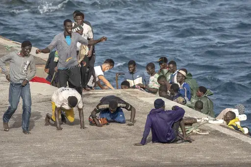 Migrants react as they arrive at the port in La Restinga on the Canary island of El Hierro, Spain, on, Aug. 19, 2024. (AP Photo/Maria Ximena, File)