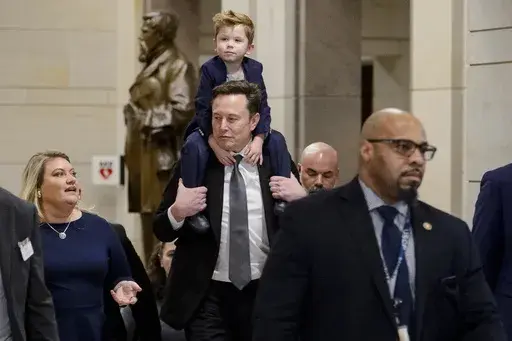 Elon Musk, President-elect Donald Trump's pick for the planned Department of Government Efficiency, carries his son X Æ A-Xii on his shoulders, following a meeting with members of Congress at the Capitol, Thursday, Dec. 5, 2024, in Washington. (AP Photo/Rod Lamkey, Jr.)