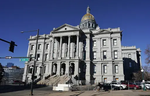A lone cyclist passes by Colorado's State Capitol building, Friday, Jan. 15, 2021, in Denver. Colorado passed a law Thursday, May 25, 2023, requiring that patients give informed consent for medical students to perform pelvic exams on them while they are unconscious. (AP Photo/David Zalubowski, File)