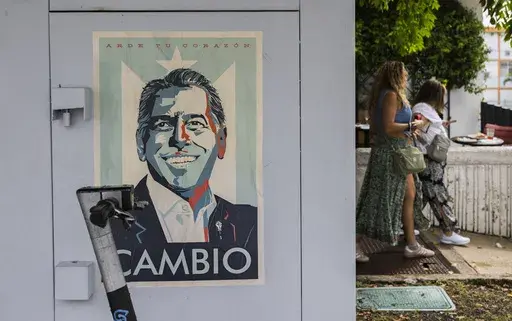 A campaign poster promoting the Puerto Rico’s Independence Party and the Citizen Victory Movement gubernatorial candidate Juan Dalmau, is displayed on an electrical box in San Juan, Puerto Rico, Saturday, Nov. 2, 2024. (AP Photo/Alejandro Granadillo)