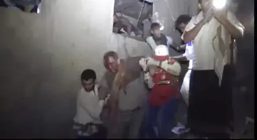 This photo provided by Ansar Allah Media Office, a man is rescued early Friday, Jan. 21, 2022, after Saudi-led airstrikes targeted a site in the contested city of Hodeida, Yemen.  A Saudi-led airstrike targeting a prison run by Yemen's Houthi rebels killed and wounded detainees on Friday, rescuers said, part of a pounding aerial offensive that hours earlier saw another airstrike take the Arab world's poorest country off the internet.  (Ansar Allah Media Office via AP)