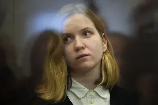 Darya Trepova, a suspect in a bombing that killed a well-known Russian military blogger, stands in a glass cage as she attends a court hearing in the 1st Western District Military Court, in St. Petersburg, Russia, Wednesday, Nov. 15, 2023. A military court in St Petersburg starts a trial against a 26-year-old woman Darya Trepova who is charged with terrorism after an attack at a St. Petersburg cafe that killed Russian military blogger Vladlen Tatarsky. (AP Photo/Dmitri Lovetsky)