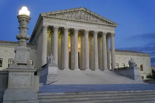 Light illuminates part of the Supreme Court building at dusk on Capitol Hill in Washington, Nov. 16, 2022. In courtrooms across America, defendants get additional prison time for crimes that juries found they didn’t commit. The Supreme Court is being asked, again, to put an end to the practice.(AP Photo/Patrick Semansky, File)
