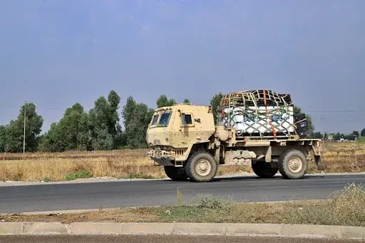 A U.S. military vehicle, part of a convoy, arrives near Dahuk, Iraq, Oct. 21, 2019. Twenty years after the U.S. invaded Iraq, in blinding explosions of shock and awe, American forces remain in the country in what has become a small, but consistent presence to ensure an ongoing relationship with a key military and diplomatic partner in the Middle East. (AP Photo/File)