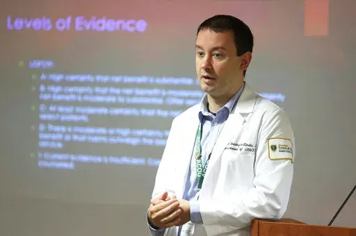 Dr. Keith Reisinger-Kindle, associate director of the OB-GYN residency program at Wright State University's medical school in Dayton, Ohio, leads a lecture of OB-GYN residents in the Wright State program Wednesday, April 13, 2022. (AP Photo/Paul Vernon)