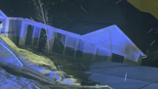 This image provided by the City of Draper, Utah, shows one of two unstable homes that collapsed down a hill in Draper, Utah on Saturday, April 22, 2023. No one was injured when the unoccupied houses broke apart. Officials, who had ordered occupants of the two homes to evacuate the properties in late October 2022, say the homes had been in danger due to sliding that resulted from shifting ground and breaks in the foundations. (City of Draper, Utah, via AP)