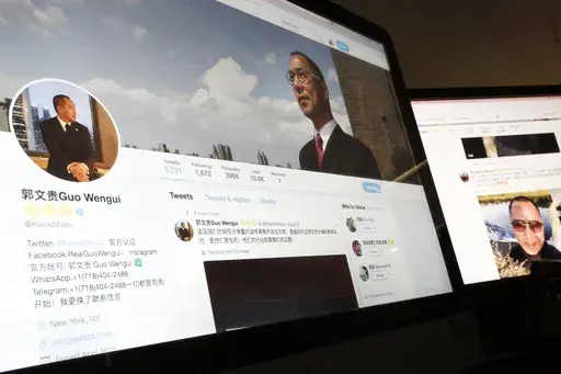 A Twitter page of Chinese exiled businessman Guo Wengui is seen on a computer screen in Beijing, Aug. 30, 2017. The self-exiled Chinese businessman long sought by the government of China, and known for cultivating ties to Trump administration figures including Steve Bannon, was arrested Wednesday, March 15, 2023, in New York on charges that he oversaw a billion dollar fraud conspiracy. Guo Wengui, also known as Ho Wan Kwok, and his financier, Kin Ming Je, were charged in an indictment in Manhatt