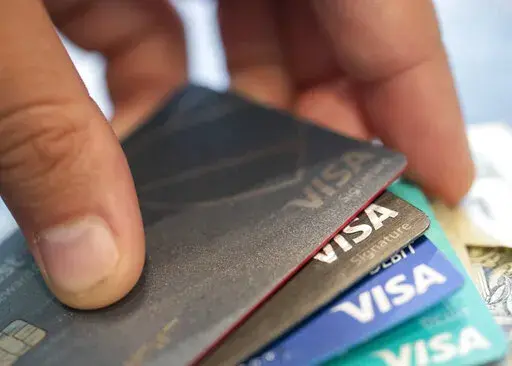 This Aug. 11, 2019 file photo shows Visa credit cards in New Orleans.  If you’re trying to navigate inflation costs, some lesser-known money moves can unlock savings on your credit card. Whether you’re looking to ditch an annual fee, earn better rewards or make the most of cardholder incentives, familiarize yourself with actions that can free up money to put toward other goals.  (AP Photo/Jenny Kane, File)