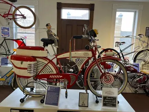 This modified 1953 Schwinn DX that was used in the 1985 film "Pee-wee’s Big Adventure," starring Paul Reubens as Pee-wee Herman, appears at the Bicycle Museum of America in New Bremen, Ohio on Dec. 26, 2022. The museum traces the bike's impact on culture, transportation and plain ol’ fun, showing how it became synonymous with convenience and ease. (Steve Wartenberg via AP)