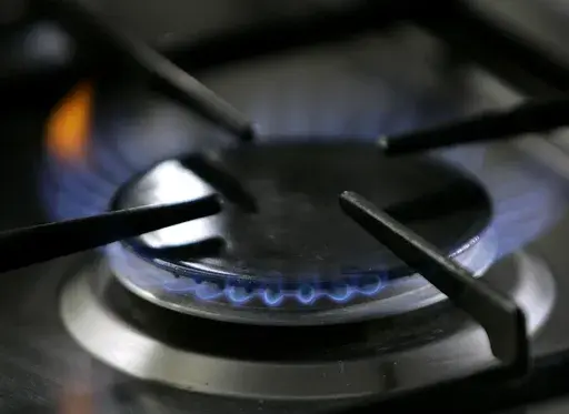 A gas-lit flame burns on a natural gas stove on Jan. 11, 2006. The Republican-controlled House is taking up legislation that GOP lawmakers say would protect gas stoves from over-zealous government regulators. (AP Photo/Thomas Kienzle, File)