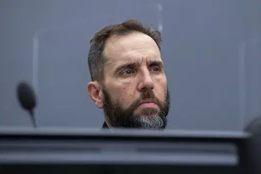 Prosecutor Jack Smith waits for the start of the court session of Kadri Veseli's initial appearance at the Kosovo Specialist Chambers court in The Hague, Netherlands, Nov. 10, 2020. Smith, the prosecutor named as special counsel to oversee investigations related to former President Donald Trump, has a long career confronting public corruption and war crimes. (AP Photo/Peter Dejong, Pool, File)