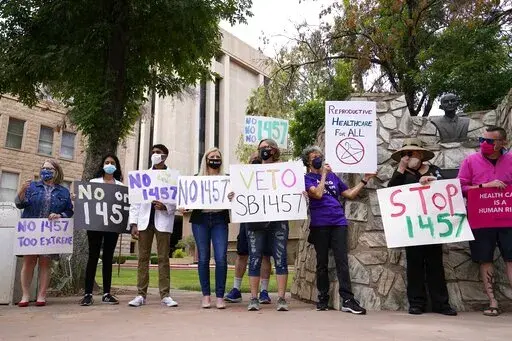 A number of Arizona reproductive health, rights, and justice advocates protest an abortion bill at the Arizona Capitol on Monday, April 26, 2021, in Phoenix. The Arizona Legislature has approved a ban on abortion after 15 weeks. The House approved the measure Thursday, March 24, 2022, a month after the Senate gave its ok, and it now heads to Republican Gov. Doug Ducey for his expected signature. (AP Photo/Ross D. Franklin, File)
