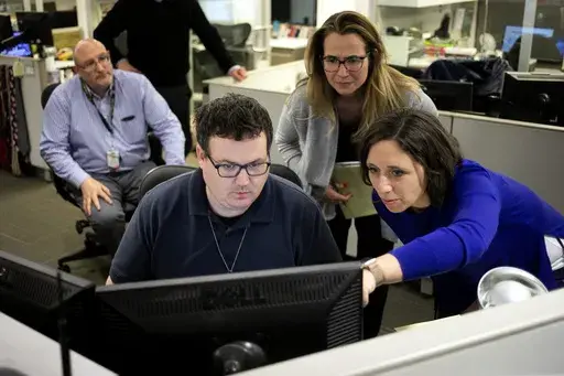 Associated Press Washington Bureau Chief Julie Pace, right, looks over a headline with deputy managing editor for operations David Scott in the newsroom at the Associated Press in Washington, Feb. 5, 2020. (AP Photo/Jenny Kane, File)