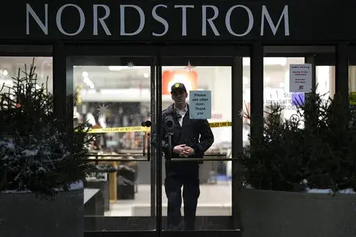 An officer stands inside Nordstrom at Mall of America after a shooting, Friday, Dec. 23, 2022, in Bloomington, Minn. A suspect wanted in connection with the fatal shooting at the mall in December was arrested in Georgia on Tuesday, Jan. 17, 2023. (AP Photo/Abbie Parr)
