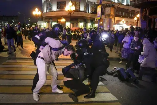 Riot police detain two young men at a demonstration in Moscow, Russia, on Sept. 21, 2022. The crackdown by Russian President Vladimir Putin affects not only opposition politicians but also independent voices and those who don't conform to what the Kremlin sees as the country's "traditional values." (AP Photo, File)