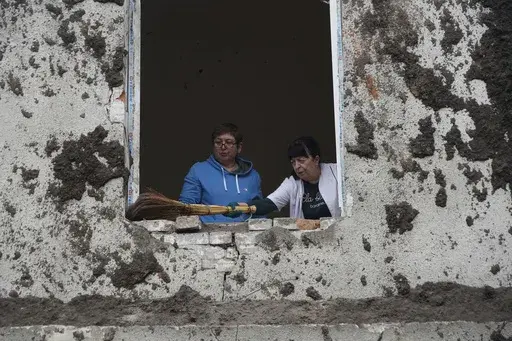 Nurses clean up in the room after a Russian attack on mental hospital №3 in Kharkiv, Ukraine, Saturday, April 27, 2024. (AP Photo/Andrii Marienko)