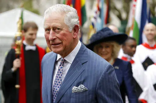 In this Monday, March 9, 2020, photo, Britain's Prince Charles and Camilla the Duchess of Cornwall, in the background, leave after attending the annual Commonwealth Day service at Westminster Abbey in London.  The Prince of Wales has edited an edition of British African-Caribbean newspaper “The Voice” to mark its 40-year anniversary. (AP Photo/Kirsty Wigglesworth, File)