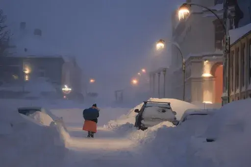 People fight their way through the snowstorm in Kristiansand, Norway, Wednesday, Jan. 3, 2024. Temperatures below minus 40 degrees Celsius (minus 40 Fahrenheit) continued to be recorded in the Nordic region with a 25-year-old record for January night being recorded in the Swedish Arctic as a cold spell continued to grip the Nordic region. (Tor Erik Schroder/NTB Scanpix via AP)