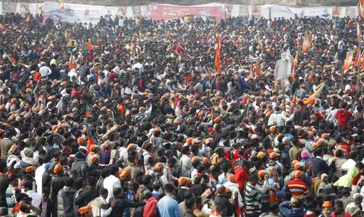 A crowd of supporters gather to listen to Indian Prime Minister Narendra Modi as he lays the foundation stone of Major Dhyan Chand Sports University in Meerut, Uttar Pradesh state on Jan. 2, 2022. Coronavirus cases fueled by the highly transmissible omicron variant have rocketed through India and the country is scrambling to ward off its impact by swiftly introducing a string of restrictions that the population thought were history. But India’s political leaders, including Modi, have largely f