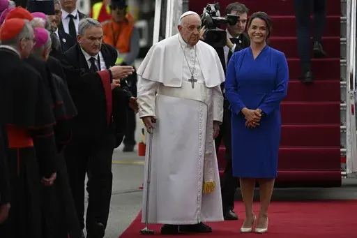 Pope Francis is greeted by Hungary President Katalin Novak during the farewell ceremony at the Budapest International Airport in Budapest, Hungary, Sunday, April 30, 2023. (AP Photo/Denes Erdos)