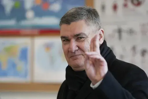 Croatia's President Zoran Milanovic greets the media after his vote during a presidential election at a polling station in Zagreb, Croatia, Sunday, Dec. 29, 2024. (AP Photo/Darko Bandic)