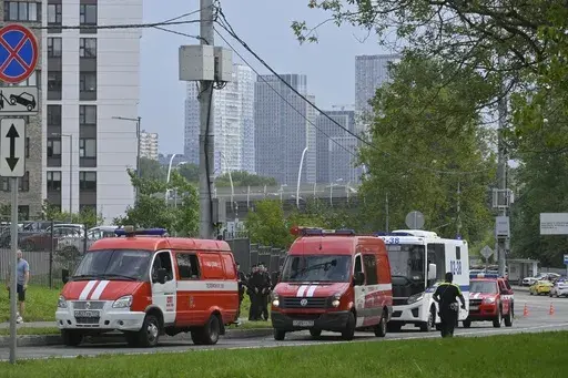 Police and emergency vehicles parked at the side of the wreckage of the drone fell near the Karamyshevskaya embankment to the after a reported drone attack in Moscow, Russia, on Friday, Aug. 11, 2023. The Mayor of Moscow, Sergei Sobyanin said a drone fell in western Moscow after it was shot down by air defense systems. Sobyanin said no-one was hurt when the drone fell near Karamyshevskaya embankment and that no serious damage was caused. Russian social media channels shared videos of what they s