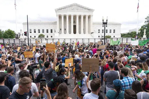 Protesters gather outside the Supreme Court in Washington, Friday, June 24, 2022. After the U.S. Supreme Court revoked the federal right to an abortion that's been in place for half a century, companies like Amazon, Disney, Apple and JP Morgan pledged to cover travel costs for employees who live in states where the procedure is now illegal so they can terminate pregnancies. (AP Photo/Jacquelyn Martin, File)