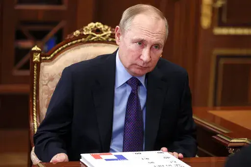 Russian President Vladimir Putin listens during a meeting in Moscow, Russia, Thursday, Dec. 30, 2021. (Alexei Nikolsky, Sputnik, Kremlin Pool Photo via AP)