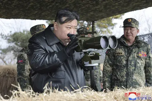 In this photo provided by the North Korean government, North Korean leader Kim Jong Un, left, supervises artillery firing drills in North Korea Thursday, March 7, 2024. Independent journalists were not given access to cover the event depicted in this image distributed by the North Korean government. The content of this image is as provided and cannot be independently verified. Korean language watermark on image as provided by source reads: "KCNA" which is the abbreviation for Korean Central News