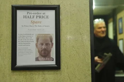 A promotional poster of the new book "Spare"is displayed in a bookstore in London, Thursday, Jan. 5, 2023. Prince Harry alleges in a much-anticipated new memoir that his brother Prince William lashed out and physically attacked him during a furious argument over the brothers' deteriorating relationship, The Guardian reported Thursday. The newspaper said it obtained an advance copy of the book, "Spare," due to be published next week. (AP Photo/Kin Cheung)