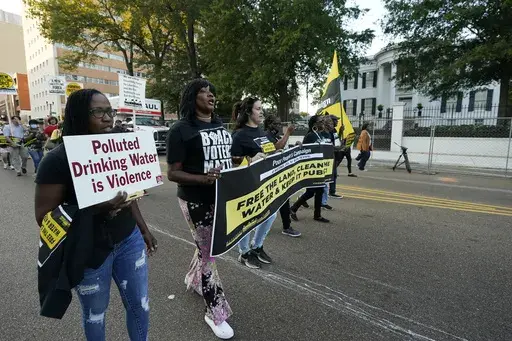 Jackson residents and supporters march with members of the Poor People's Campaign of Mississippi to the Governor's Mansion in Jackson, Miss., to protest water system problems, poverty and other issues, Oct. 10, 2022. A lawsuit filed Friday, June 2, 2023, challenges a new Mississippi law that will require people to receive state law enforcement permission before protests near state government buildings in Jackson. (AP Photo/Rogelio V. Solis, file)