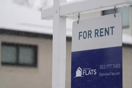 A for rent sign stands outside a single-family home on the market Saturday, Feb. 10, 2024, in Denver. A record number of Americans who rent are now considered cost-burdened, with 30% or more of their income going toward rent and utilities. Companies like Flex, which let you divide your rent into smaller installments via a line of credit or loan, say they’re part of the solution. (AP Photo/David Zalubowski, File)