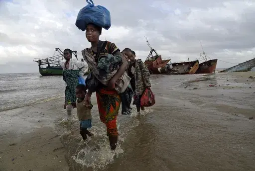 FILE — Displaced families arrive after being rescued by boat from a flooded area of Buzi district, 200 kilometers (120 miles) outside Beira, Mozambique, Saturday, March 23, 2019. Much of the world takes daily weather forecasts for granted. But most of Africa's 1.3 billion people live with little advance knowledge of what's to come. That can be deadly, with damage running in the billions of dollars. The first Africa Climate Summit opens this week in Kenya to highlight the continent that will su