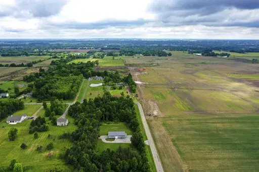 This aerial image taken with a drone on June 9, 2022 shows a portion of land in Johnstown, Ohio, where Intel plans to build two new processor factories. The houses on the left are up for demolition. Intel Corp. plans a Sept. 9 groundbreaking for its planned $20 billion Ohio semiconductor operations with President Joe Biden giving remarks, the company and the the White House said Thursday, Aug. 25, 2022. (AP Photo/Gene J. Puskar, File)
