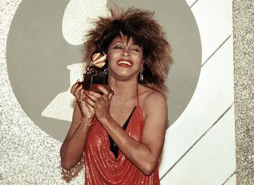 Tina Turner, Pop and R&B vocalist, as holds up a Grammy Award, Feb. 27, 1985, in Los Angeles. Turner, the unstoppable singer and stage performer, died Wednesday, after a long illness at her home in Küsnacht near Zurich, Switzerland, according to her manager. She was 83 (AP Photo/Nick Ut, File)