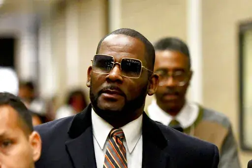 Musician R. Kelly, center, leaves the Daley Center after a hearing in his child support case on May 8, 2019, in Chicago. Closing arguments are scheduled Monday, Sept. 12, 2022 for R. Kelly and two co-defendants in the R&B singer’s trial on federal charges of trial-fixing, child pornography and enticing minors for sex, with jury deliberations to follow. (AP Photo/Matt Marton, File)