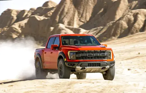 This photo provided by Ford Motor Co. shows the 2021 Ford F-150 Raptor, a full-size pickup truck that has been heavily modified from the factory for high-speed desert drives. We’re in a golden age of off-road pickup trucks that you can buy straight from the factory, and the Ford F-150 Raptor and Ram 1500 TRX are the most high-profile examples. (Courtesy of Ford Motor Co. via AP)