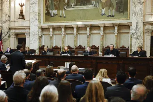 The Wisconsin Supreme Court listens to arguments from Wisconsin Assistant Attorney General Anthony D. Russomanno, representing Gov. Tony Evers, during a redistricting hearing at the state Capitol, Nov. 21, 2023, in Madison, Wis. The liberal-controlled Wisconsin Supreme Court overturned Republican-drawn legislative maps on Friday, Dec. 22, and ordered that new district boundary lines be drawn as Democrats had urged in a redistricting case they hope will weaken GOP majorities. (Ruthie Hauge/The Ca