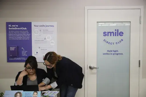 Dental assistants go over appointments at SmileDirectClub's SmileShop located inside a CVS store April 24, 2019, in Downey, Calif. SmileDirectClub is shutting down, just months after the struggling teeth-straightening company filed for bankruptcy, leaving existing customers in limbo. On Friday, Dec. 8, 2023, the company said it was unable to find a partner willing to bring in enough capital to keep the company afloat, despite a months-long search. (AP Photo/Jae C. Hong)