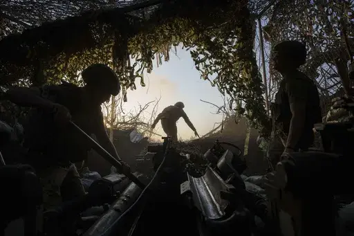 Ukrainian servicemen of 148th separate artillery brigade of the Air Assault Forces prepare a M777 howitzer to fire towards Russian positions at the frontline in Donetsk region, Ukraine, Wednesday, August 21, 2024. (AP Photo/Evgeniy Maloletka)