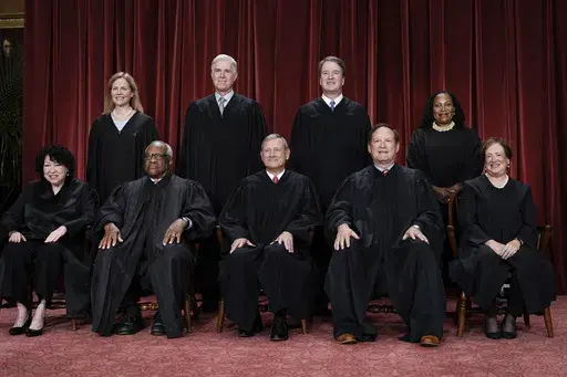 Members of the Supreme Court sit for a new group portrait following the addition of Associate Justice Ketanji Brown Jackson, at the Supreme Court building in Washington, Oct. 7, 2022. Bottom row, from left, Associate Justice Sonia Sotomayor, Associate Justice Clarence Thomas, Chief Justice of the United States John Roberts, Associate Justice Samuel Alito, and Associate Justice Elena Kagan. Top row, from left, Associate Justice Amy Coney Barrett, Associate Justice Neil Gorsuch, Associate Justice 