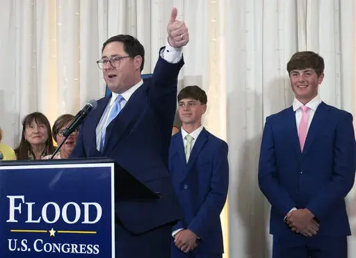Mike Flood delivers a victory speech alongside sons Brenden and Blake at an election night party on Tuesday, June 28, 2022, at Midtown Event Center in Norfolk, Neb. Nebraska state Sen. Mike Flood won a special election Tuesday to replace former U.S. Rep. Jeff Fortenberry, a fellow Republican who was sentenced to two years of probation earlier in the day for a conviction on charges that he lied to federal agents.(Gwyneth Roberts/Lincoln Journal Star via AP)