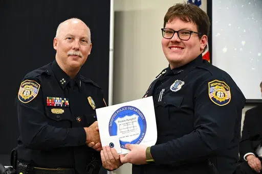 In this photo obtained from the Memphis Police Department's Facebook page, Preston Hemphill receives a certificate from Memphis Assistant Chief of Police Don Crowe after completing the training to join the department's Crisis Intervention Team on July 21, 2022. Police officials said Monday, Jan. 30, 2023, that Hemphill and another officer were relieved of duty in connection with the death of Tyre Nichols, widening the circle of punishment for the shocking display of police brutality after video 