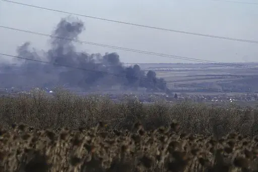 Smoke billows during fighting between Ukrainian and Russian forces in Soledar, Donetsk region, Ukraine, Wednesday, Jan. 11, 2023. Soledar and Bakhmut again highlighted a bitter rift between the top military brass and Yevgeny Prigozhin, a rogue millionaire whose Wagner Group military contractor has played an increasing role in Ukraine. (AP Photo/Libkos, File)