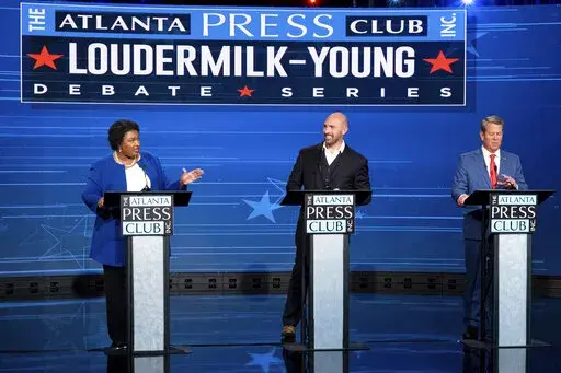 Democratic challenger Stacey Abrams, from left, Libertarian challenger Shane Hazel and Georgia Republican Gov. Brian Kemp debate during the Atlanta Press Club Loudermilk-Young Debate Series in Atlanta, Monday, Oct. 17, 2022. (AP Photo/Ben Gray)