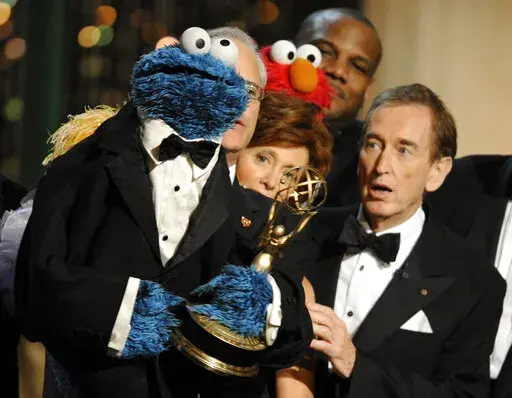 Bob McGrath, right, looks at the Cookie Monster as they accept the Lifetime Achievement Award for '"Sesame Street" at the Daytime Emmy Awards on Aug. 30, 2009, in Los Angeles. McGrath, an actor, musician and children’s author widely known for his portrayal of one of the first regular characters on the children’s show “Sesame Street” has died at the age of 90. McGrath’s passing was confirmed by his family who posted on his Facebook page on Sunday, Dec. 4, 2022. (AP Photo/Chris Pizzello,