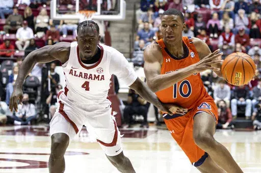 Auburn forward Jabari Smith (10) works around Alabama forward Juwan Gary (4) during the first half of an NCAA college basketball game, Tuesday, Jan. 11, 2022, in Tuscaloosa, Ala. (AP Photo/Vasha Hunt)